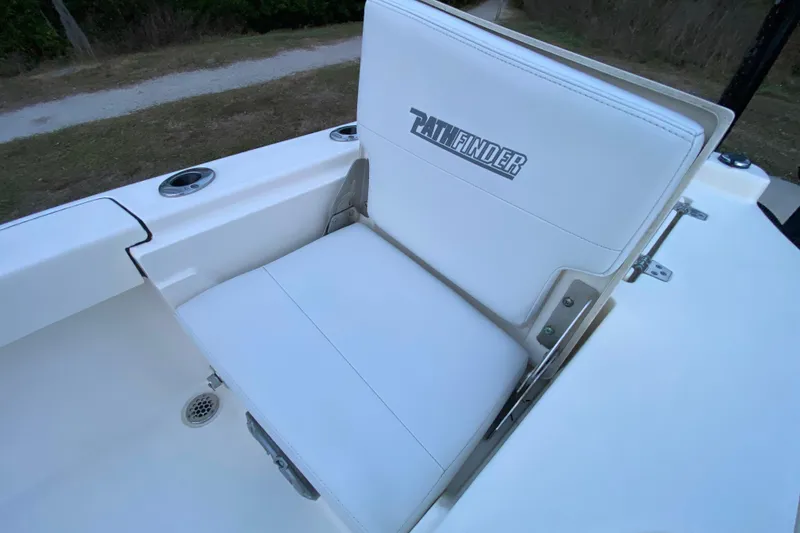Slide: The Image of 2020 Pathfinder 2500 Hybrid boat seat with logo, featuring white upholstery. - 63