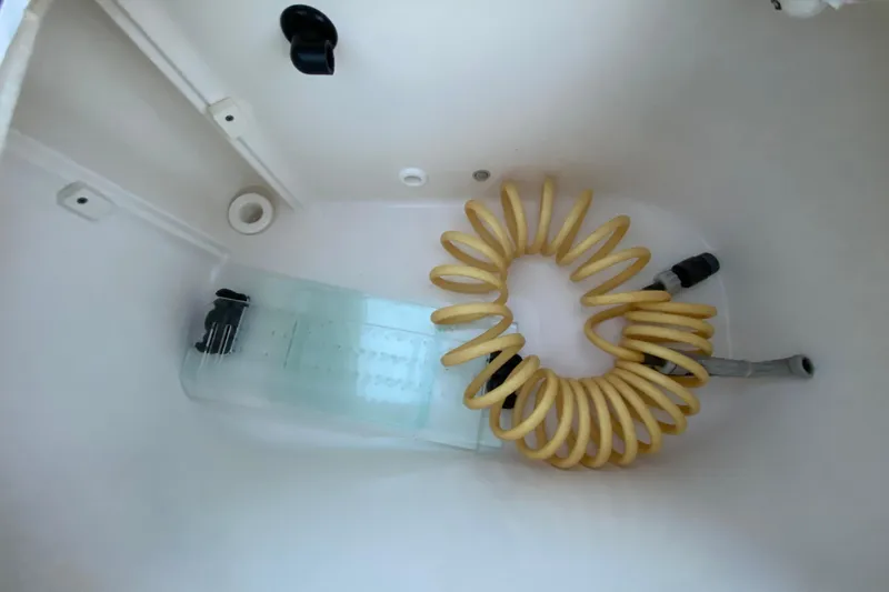 Slide: The Image of Yellow coiled hose in a Pathfinder 2500 Hybrid 2020 boat compartment. - 71