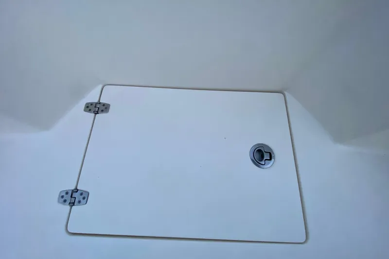 Slide: The Image of Hatch cover on 2020 Pathfinder 2500 Hybrid boat, featuring metal hinges and handle. - 77