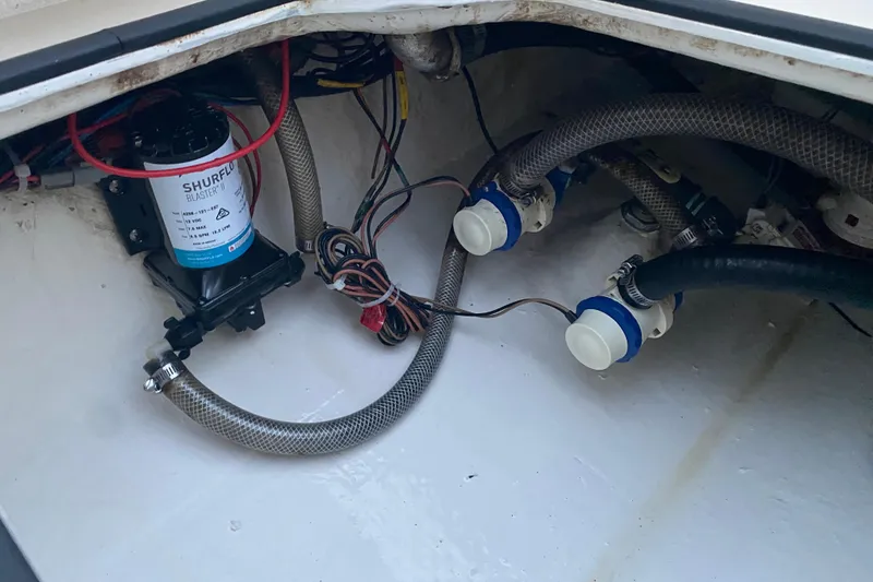Slide: The Image of Boat plumbing system in a 2020 Pathfinder 2500 Hybrid, featuring hoses and a Shurflo pump. - 79