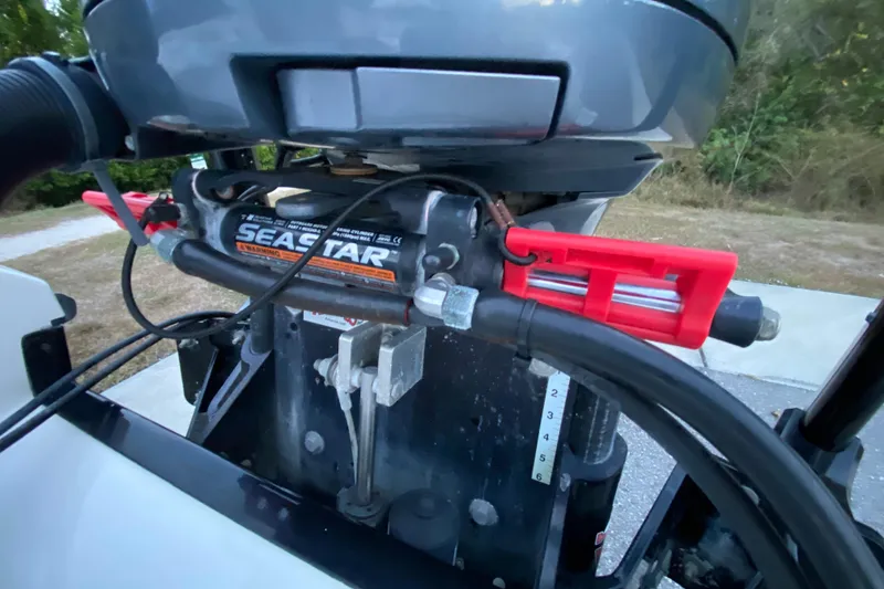 Slide: The Image of Close-up of SeaStar hydraulic steering on a 2020 Pathfinder 2500 Hybrid boat. - 81