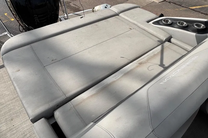 Slide: The Image of 2023 Bennington 23 SXSB boat with spacious gray seating and cup holders. - 10