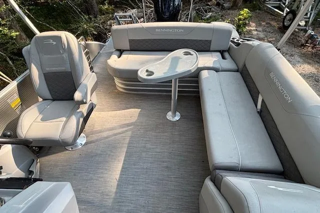 Slide: The Image of 2023 Bennington 23 SXSB boat interior with gray seating and table. - 14