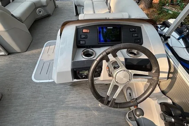 Slide: The Image of 2023 Bennington 23 SXSB boat dashboard with steering wheel and control panel. - 15
