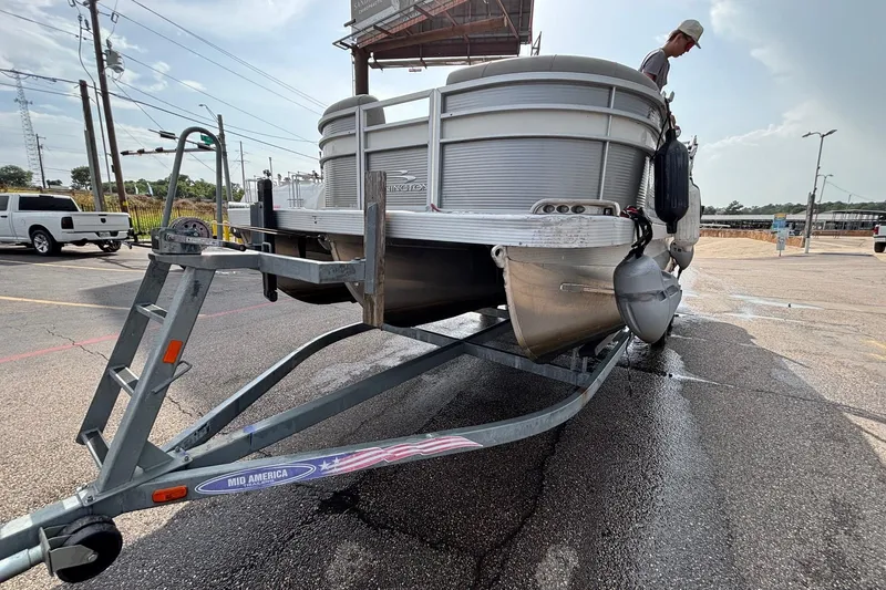Slide: The Image of 2023 Bennington 23 SXSB pontoon boat on trailer in parking lot. - 3