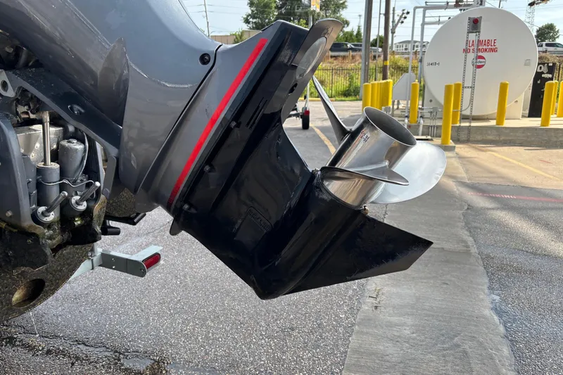 Slide: The Image of Close-up of a 2023 Bennington 23 SXSB boat motor and propeller in a parking area. - 7