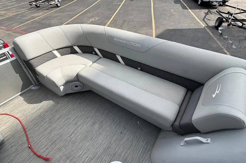 Slide: The Image of 2023 Bennington 23 SXSB pontoon boat with spacious gray seating and modern design. - 8