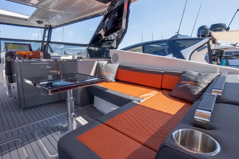 Slide: The Image of Luxurious interior of 2026 Dracan 42 Catamaran with orange seating and modern design. - 14