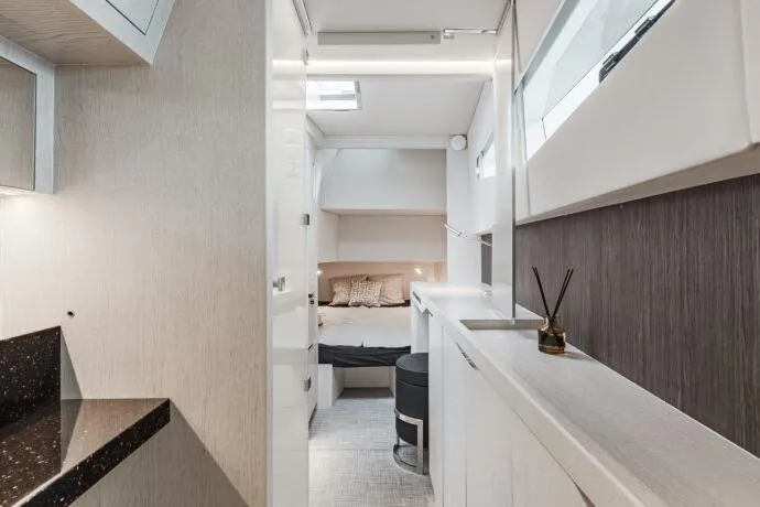 Slide: The Image of Interior of 2026 Dracan 42 Catamaran, featuring modern design and cozy sleeping area. - 28