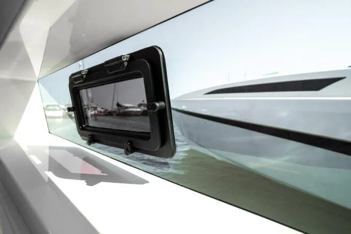 Slide: The Image of 2026 Dracan 42 Catamaran window view, showcasing sleek design and marina reflection. - 33