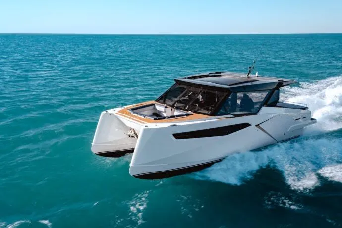 Slide: The Image of 2026 Dracan 42 Catamaran cruising on open sea under clear blue sky. - 4