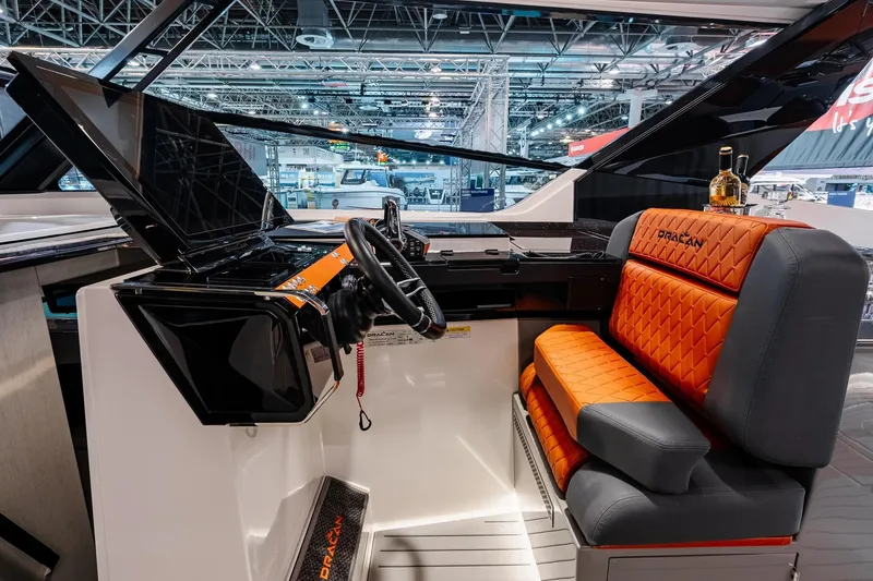 Slide: The Image of Luxurious interior of 2026 Dracan 42 Catamaran with modern helm and orange seating. - 7