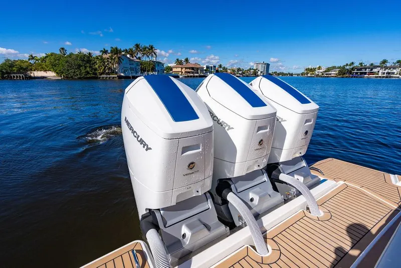 Slide: The Image of 2024 Tiara Yachts 48 LS with triple Mercury outboard engines on a sunny day. - 11