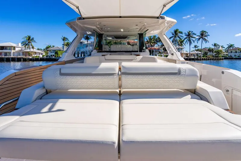 Slide: The Image of 2024 Tiara Yachts 48 LS luxury yacht with spacious seating, docked by palm trees. - 14