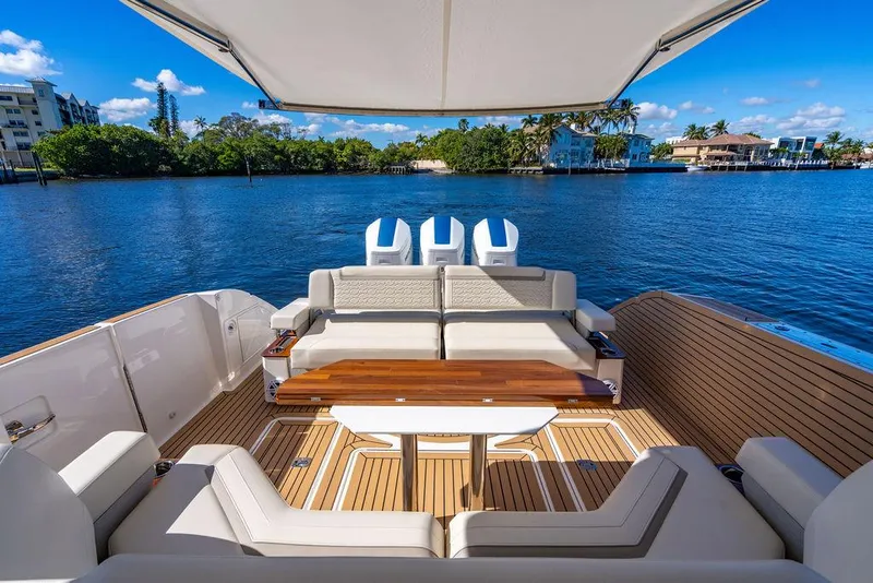 Slide: The Image of Luxurious 2024 Tiara Yachts 48 LS with elegant seating and scenic waterfront view. - 16