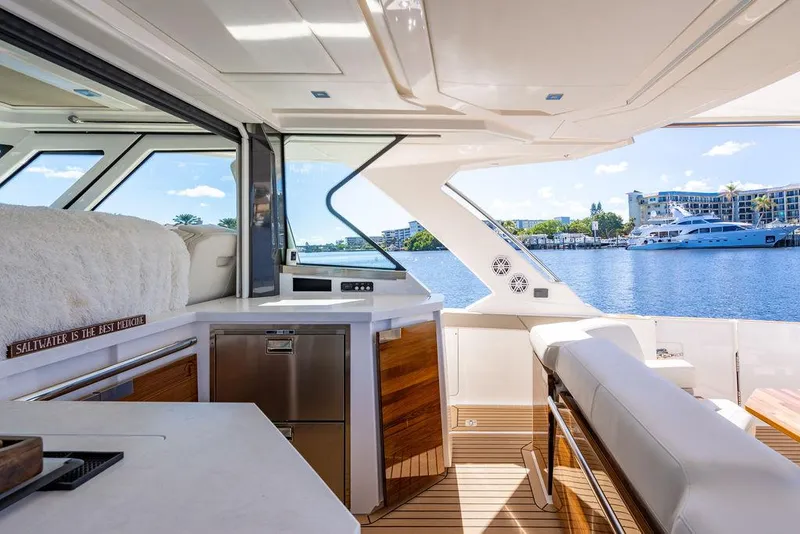 Slide: The Image of Luxurious interior of 2024 Tiara Yachts 48 LS with waterfront view. - 21