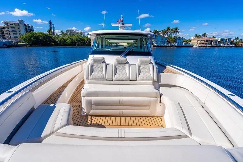 Slide: The Image of 2024 Tiara Yachts 48 LS luxury boat with spacious seating on a sunny day. - 25
