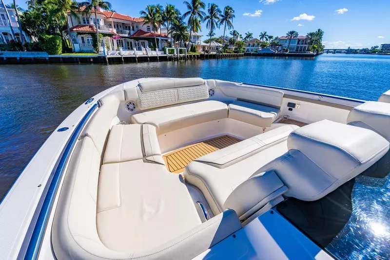 Slide: The Image of Luxurious 2024 Tiara Yachts 48 LS with spacious seating, docked by waterfront homes. - 26