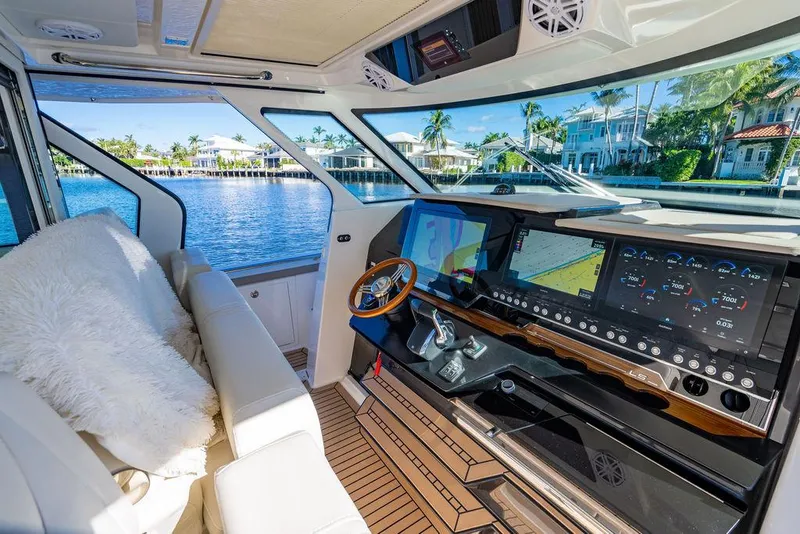 Slide: The Image of Interior of 2024 Tiara Yachts 48 LS, featuring luxurious helm and waterfront view. - 30