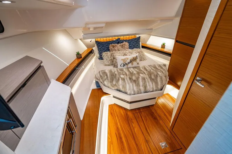 Slide: The Image of Luxurious 2024 Tiara Yachts 48 LS cabin with elegant wood flooring and plush bedding. - 38