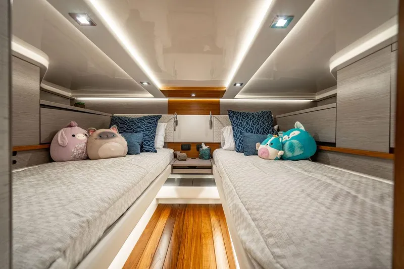 Slide: The Image of Luxurious 2024 Tiara Yachts 48 LS cabin with plush bedding and decorative pillows. - 44