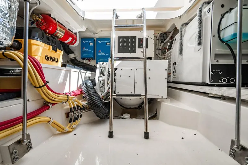 Slide: The Image of Engine room of 2024 Tiara Yachts 48 LS with equipment and wiring. - 45