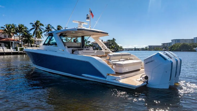 Slide: The Image of 2024 Tiara Yachts 48 LS luxury boat on sunny waterfront. - 7