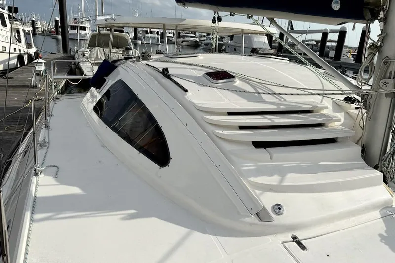 Slide: The Image of 2006 Island Spirit 401 catamaran docked at marina, showcasing sleek deck design. - 13