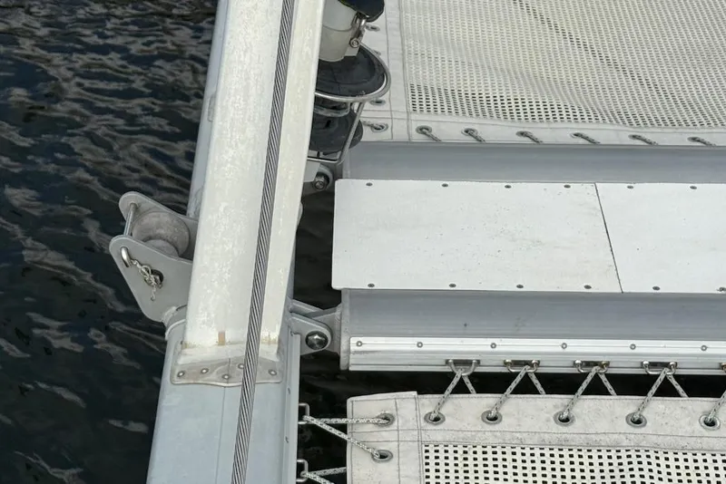 Slide: The Image of Close-up of 2006 Island Spirit 401 catamaran deck and netting over water. - 15