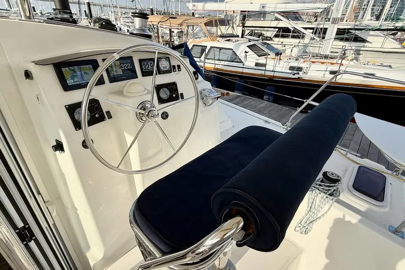 Slide: The Image of Helm of 2006 Island Spirit 401 yacht with navigation instruments and marina view. - 17