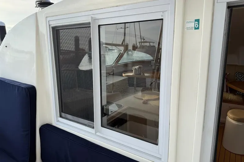 Slide: The Image of 2006 Island Spirit 401 yacht window with interior view and seating area. - 19