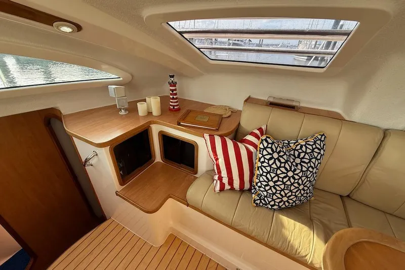 Slide: The Image of Cozy interior of 2006 Island Spirit 401 yacht with cushions and wooden accents. - 23