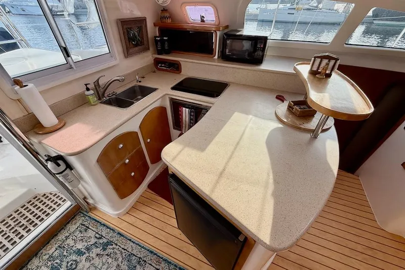 Slide: The Image of Luxurious 2006 Island Spirit 401 yacht kitchen with modern amenities and elegant design. - 24
