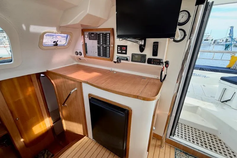 Slide: The Image of Interior of 2006 Island Spirit 401 yacht with navigation equipment and wooden cabinetry. - 27