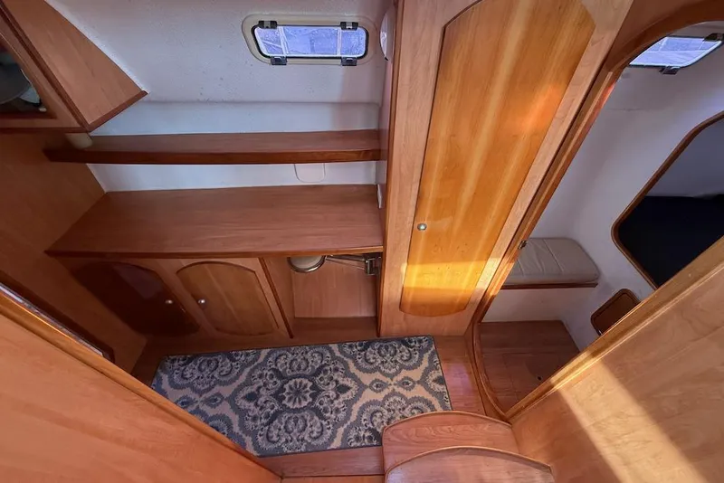 Slide: The Image of 2006 Island Spirit 401 yacht interior with wooden cabinetry and patterned rug. - 31