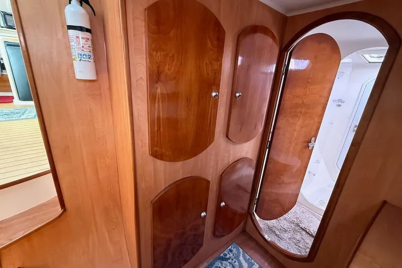 Slide: The Image of Interior of 2006 Island Spirit 401 yacht with wooden cabinets and a fire extinguisher. - 34