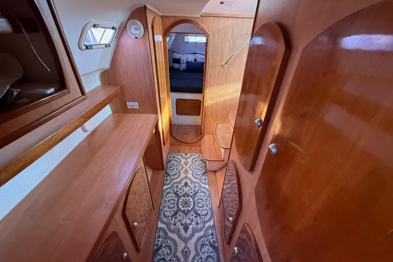 Slide: The Image of Interior of 2006 Island Spirit 401 yacht with wooden cabinetry and patterned carpet. - 35