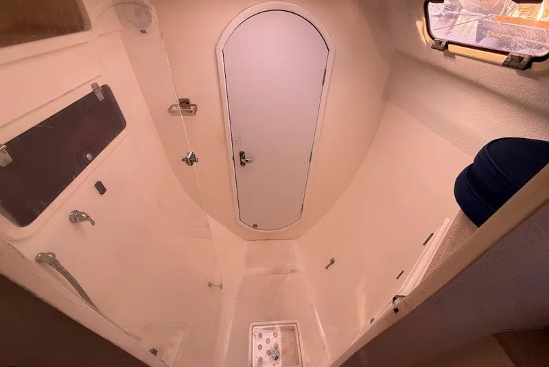 Slide: The Image of Bathroom interior of 2006 Island Spirit 401 yacht, featuring shower and porthole. - 36
