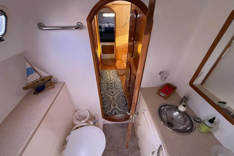 Slide: The Image of Bathroom interior of 2006 Island Spirit 401 yacht with sink, toilet, and nautical decor. - 38
