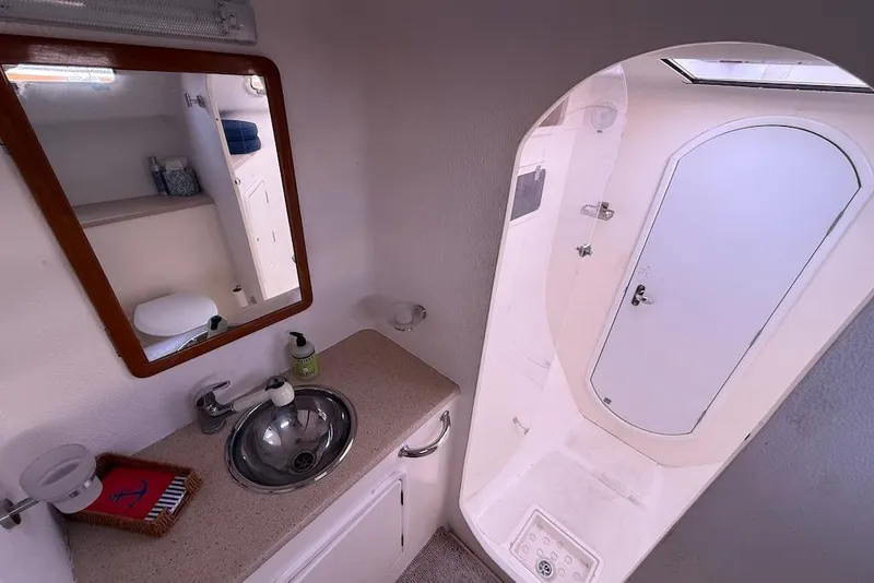 Slide: The Image of Bathroom interior of 2006 Island Spirit 401 yacht, featuring sink, mirror, and shower. - 39