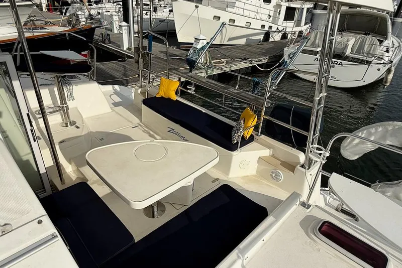Slide: The Image of 2006 Island Spirit 401 yacht interior with seating and table, docked at marina. - 4