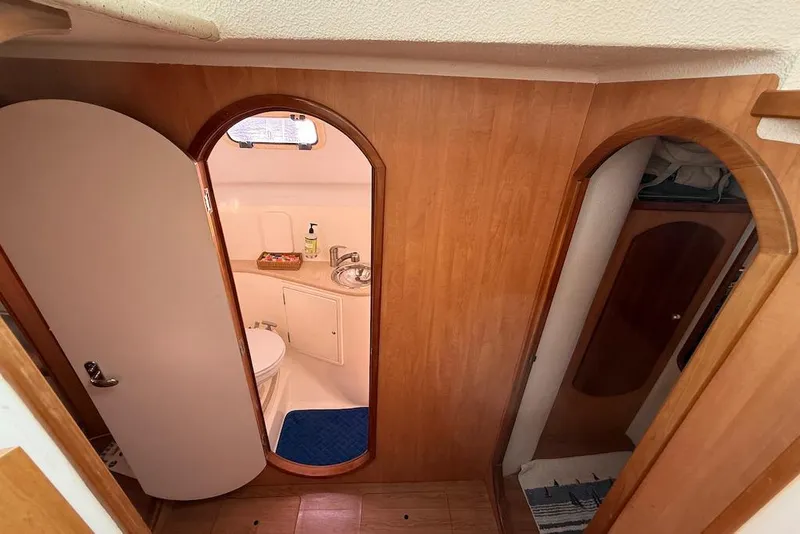 Slide: The Image of 2006 Island Spirit 401 yacht interior with wooden finish and compact bathroom. - 40