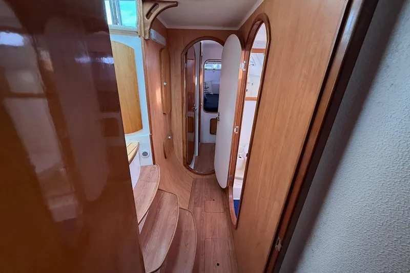 Slide: The Image of Interior view of 2006 Island Spirit 401 yacht, featuring wooden finishes and cozy cabin space. - 41