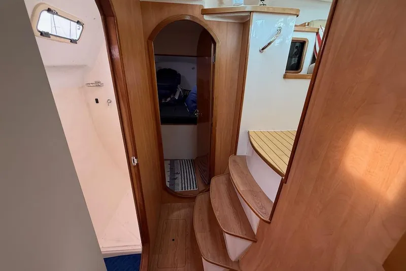 Slide: The Image of Interior of 2006 Island Spirit 401 yacht with wooden steps and cabin entrance. - 42
