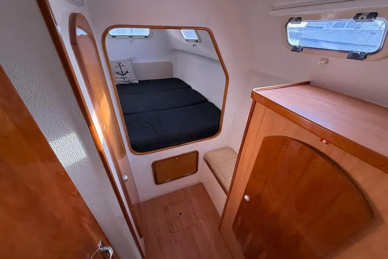 Slide: The Image of Interior cabin of 2006 Island Spirit 401 yacht with wooden finishes and cozy bed. - 43