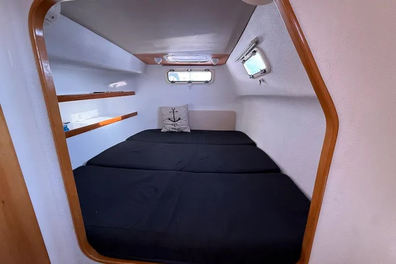 Slide: The Image of Cozy cabin interior of 2006 Island Spirit 401 yacht with black bedding and nautical decor. - 44