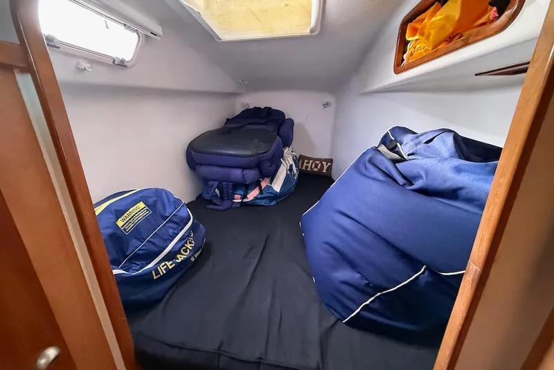 Slide: The Image of Small cabin interior of 2006 Island Spirit 401 yacht with life jackets and storage bags. - 45
