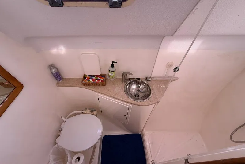 Slide: The Image of Compact bathroom in 2006 Island Spirit 401 yacht with sink, toilet, and toiletries. - 46