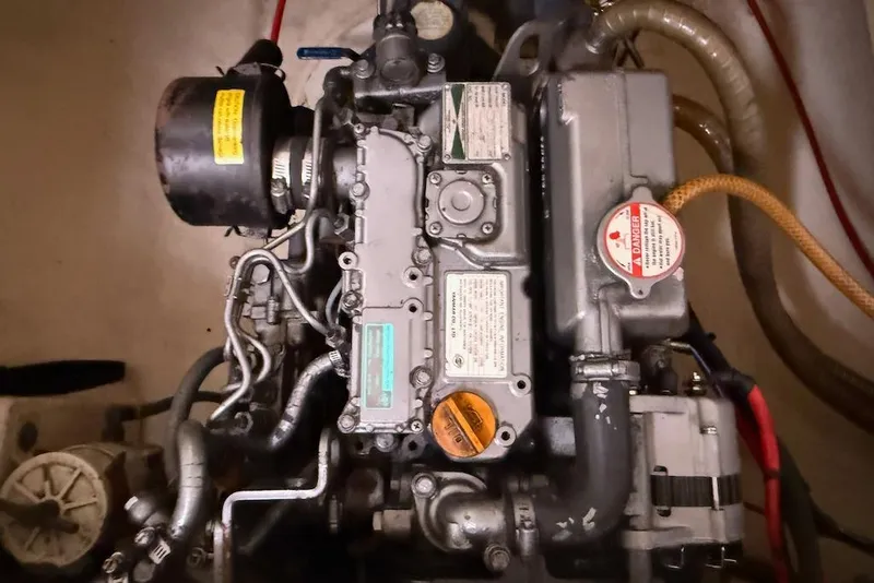 Slide: The Image of Engine of a 2006 Island Spirit 401 sailboat, showcasing mechanical components and labels. - 48