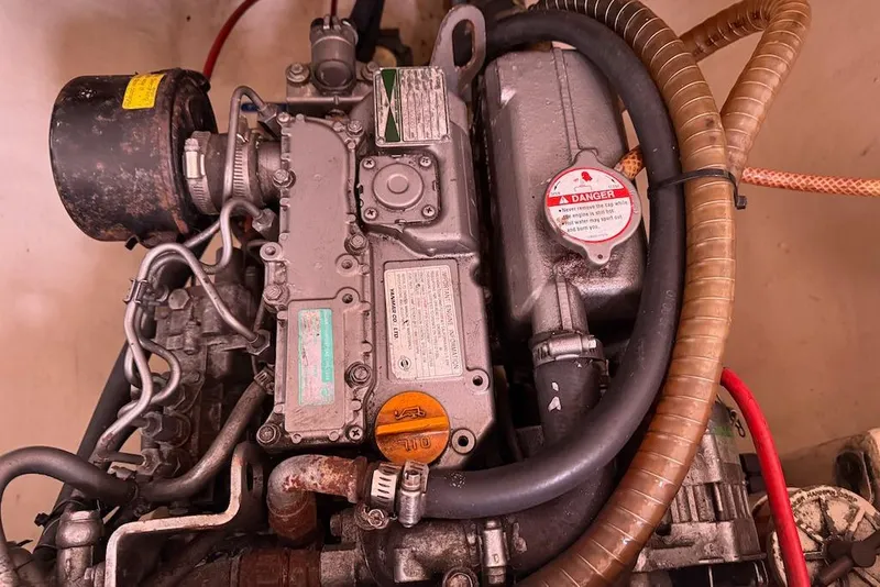 Slide: The Image of Engine compartment of a 2006 Island Spirit 401 sailboat, showing detailed mechanical components. - 49